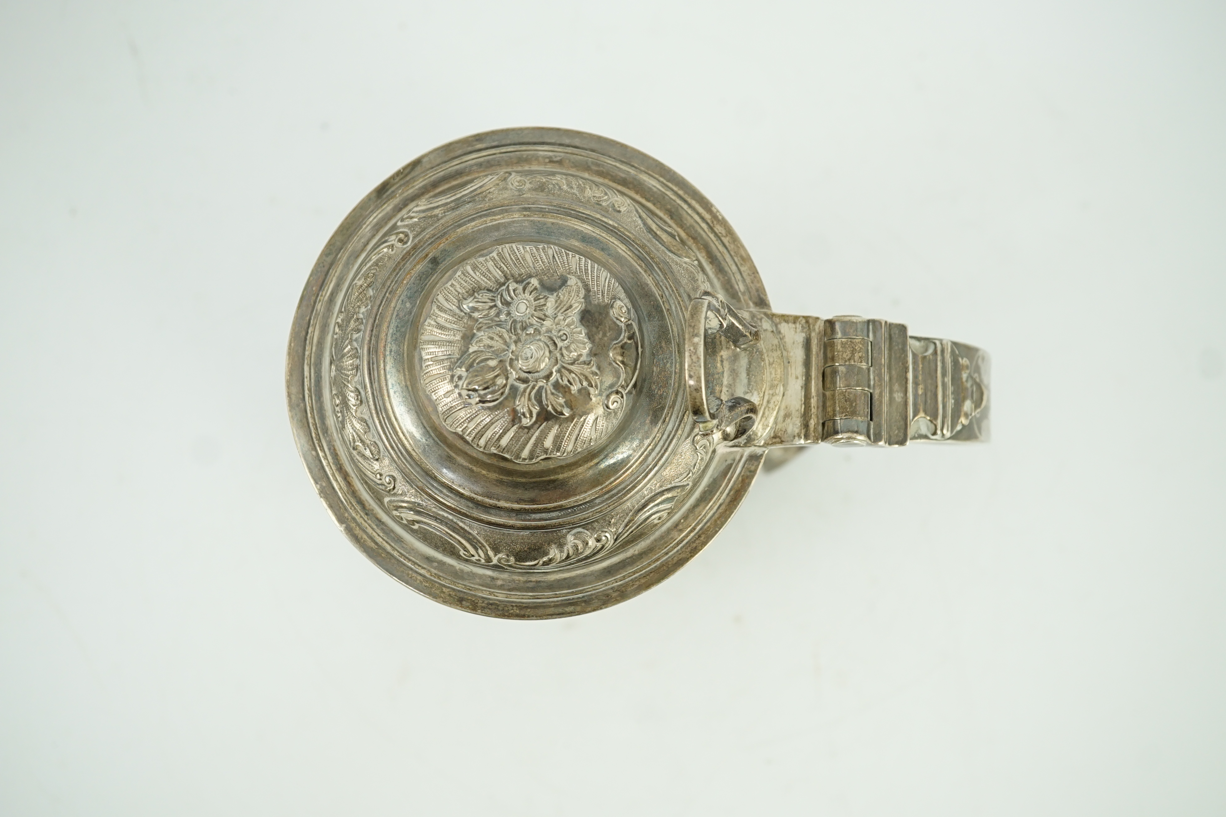 A George II silver baluster tankard, with later embossed decoration, by Robert Albin Cox